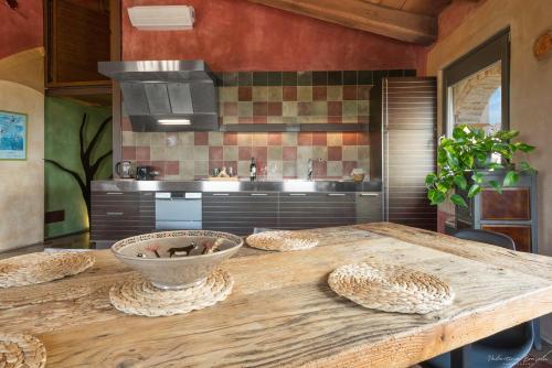 a kitchen with a wooden table with a bowl on it at Palazzo d'Assi - Guest house in Monforte dʼAlba