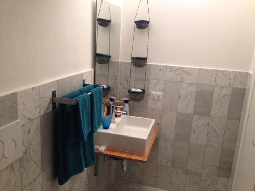 a bathroom with a sink and blue towels at Gelsomoro beach house in Campomarino