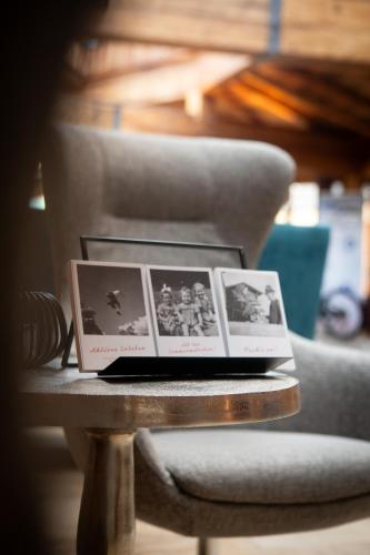 a table with four photos on top of a chair at Hotel Elisabeth, 4 Sterne Superior in Kirchberg in Tirol