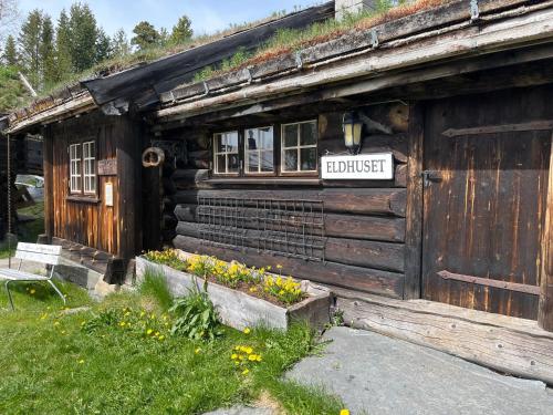 an old wooden building with a sign on it at Raulandsakademiet in Rauland