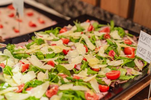 a tray of salad with meat and lettuce and tomatoes at Montresor Hotel Pfeldererhof in Pfelders
