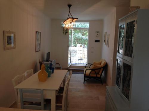 a living room with a table and a dining room at Gelsomoro beach house in Campomarino