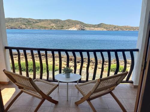 a balcony with a table and chairs and a view of the water at Roca Fornells, P131 in Fornells