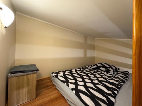 a bedroom with a zebra print bed and a wooden cabinet at Pokoje przy lesie in Jantar