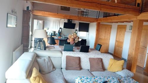 a living room with a couch with two laptops on it at Maison Chalet in Le Nayrac