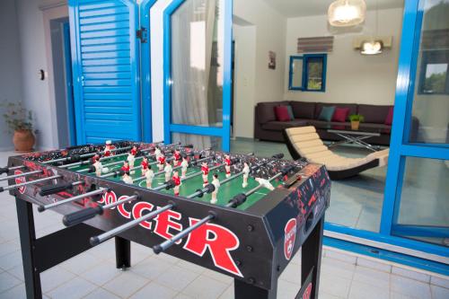 a foosball table in the middle of a living room at Villa Amor in Pefki Rhodes
