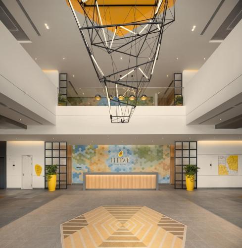 a large room with a lobby with a large ceiling at HIIVE by fusion Binh Duong - VSIP 1 in Thuan An