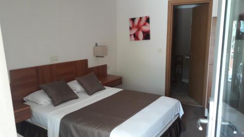 a bedroom with a large bed with brown pillows at Melis Hotel Kusadasi in Kusadası