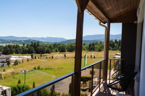 a view of a field from the balcony of a house at Family Hotel The View & SPA in Tsigov Chark