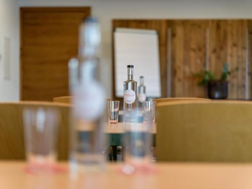a bottle of wine sitting on a table with glasses at Hotel Elisabeth, 4 Sterne Superior in Kirchberg in Tirol