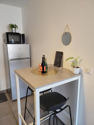 a table with two bottles of beer on it at Le Terramon - Appartement 4 personnes in Orbey