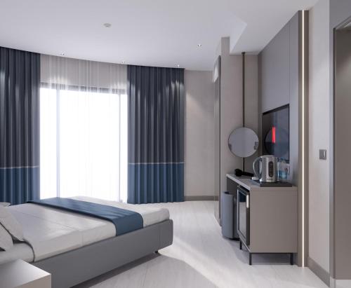 Ένα ή περισσότερα κρεβάτια σε δωμάτιο στο Echinus Blue Hotel