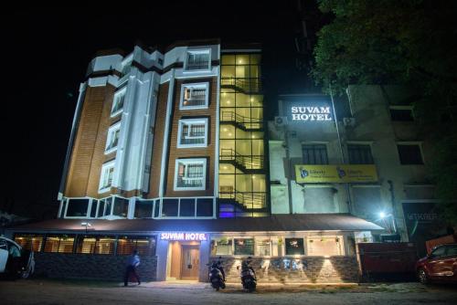 a building with two motorcycles parked in front of it at Suvam Hotel in Durgāpur