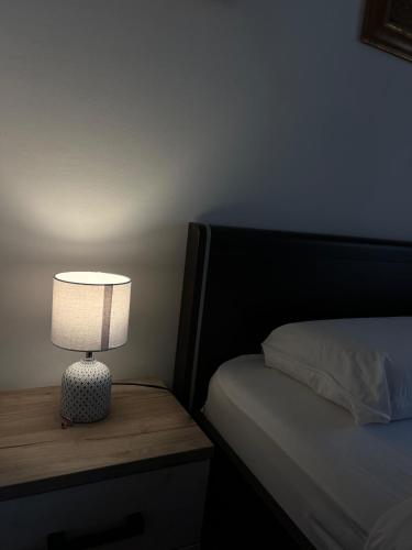 a lamp sitting on a table next to a bed at Teuta Azure Apartment - Blue Horizont Complex, Sveti Stefan in Pržno