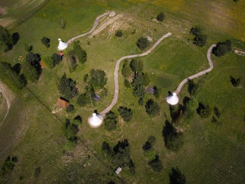 an aerial view of a park with two white tents at Briedžio sapnas in Sudervė