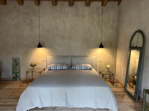 a bedroom with a large white bed with two pillows at Il Glicine - Natural BnB in Castello di Godego