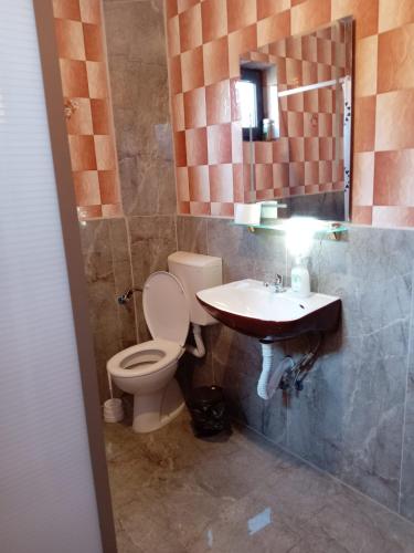 a bathroom with a toilet and a sink at Vila Nina 