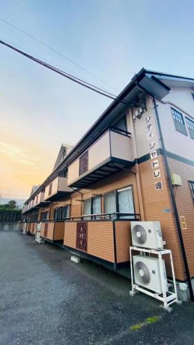 a building with a lot of windows on a street at apartment hotel myu didymi in Utsunomiya