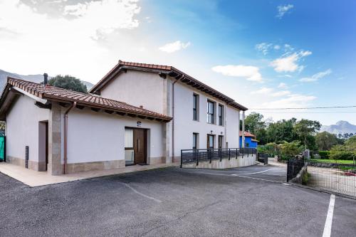 a large white building with a parking lot at 4 Terraza - Antilles sin jardin in Llanes