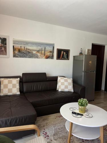 a living room with a couch and a table at Teuta Azure Apartment - Blue Horizont Complex, Sveti Stefan in Pržno