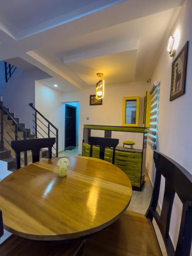 a dining room with a wooden table and chairs at 2 Bedroom Apartment Lekki in Lekki