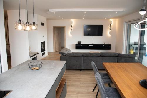 a living room with a couch and a table at Vila Altura- Luxury Hiltop Retreat with Panoramic View & Teracce in Rogaška Slatina