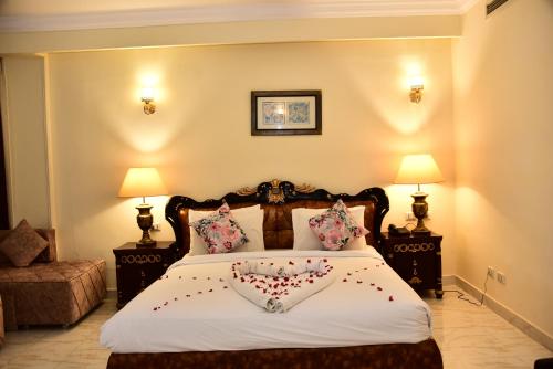 a bedroom with a bed with a heart pillow on it at Hollywood Aqua Park Sharm El-Sheikh in Sharm El Sheikh