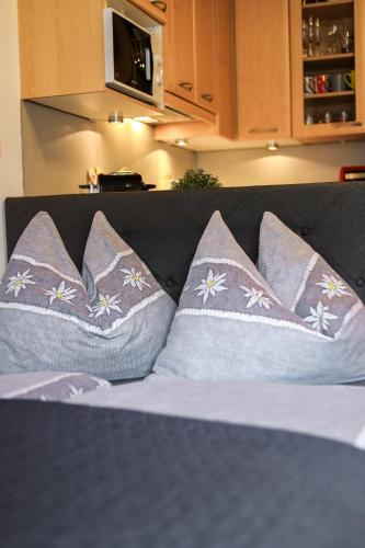 a group of pillows sitting on a couch at Winzig Apartment in Schladming