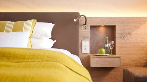 a bedroom with a bed and a table with wine glasses at Bauer Hotel und Restaurant in Feldkirchen