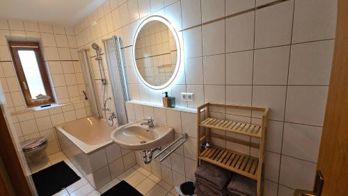 a bathroom with a sink and a mirror at Ferienwohnung am Bodensee in Nonnenhorn