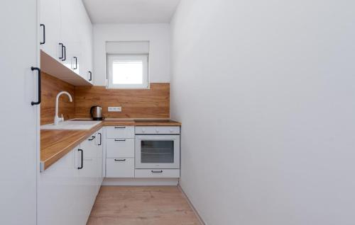 a kitchen with white cabinets and a sink at 2 Bedroom Gorgeous Apartment In Vir in Vir