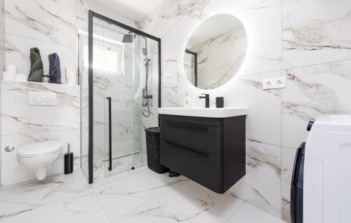 a white bathroom with a sink and a mirror at 2 Bedroom Gorgeous Apartment In Vir in Vir