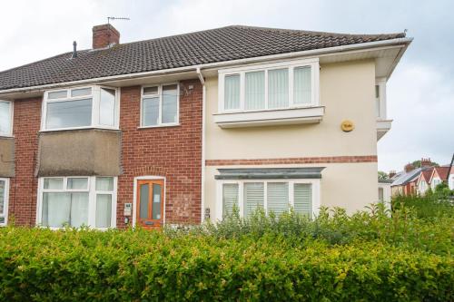 a red brick house with white windows at 2-bedroom apartment in Headington with free parking, walking distance to Oxford Hospitals & Brookes Uni in Oxford