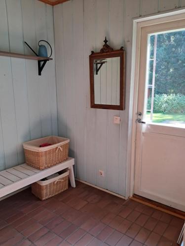 a room with a door and a bench and a mirror at Aalto A - A whole house with 5 bedrooms and a woodburning sauna in Oulu