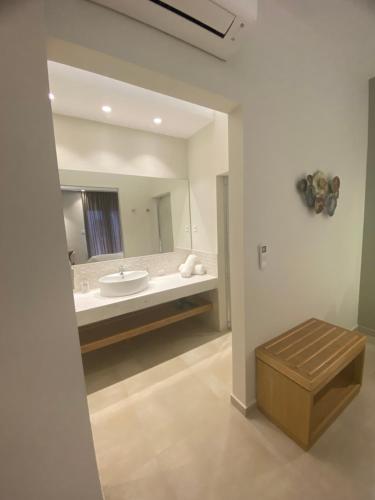 a large bathroom with a tub and a sink at Elena Village Hotel & Suites in Kalymnos