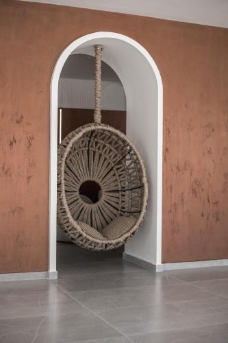 a wicker fan in a room with a wall at Aiora Resort in Pefki Rhodes
