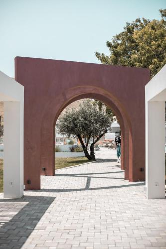 an archway in a park with people walking through it at Aiora Resort in Pefki Rhodes