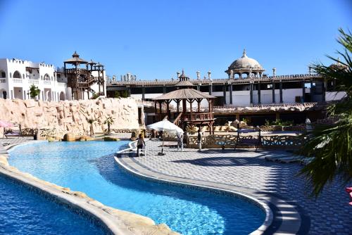 a swimming pool in a resort with a bridge in the background at Hollywood Aqua Park Sharm El-Sheikh in Sharm El Sheikh