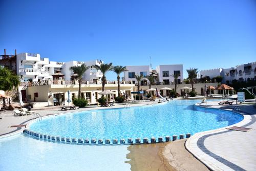a large swimming pool with buildings in the background at Hollywood Aqua Park Sharm El-Sheikh in Sharm El Sheikh