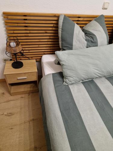 a bedroom with two beds and a wooden headboard at Ferienwohnung Edgar und 300 qm Garten Trier Mosel Eifel in Mertesdorf