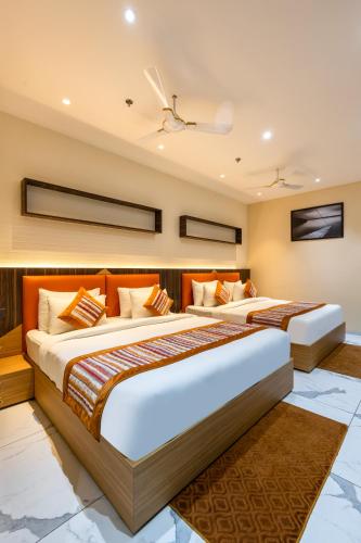 two beds in a hotel room with two beds at The SM Hotel By RMR Hotels in New Delhi