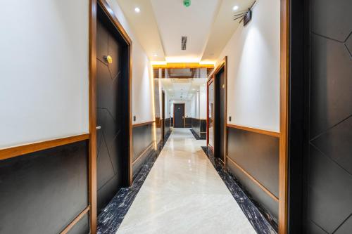 a corridor in a building with a hallway at The SM Hotel By RMR Hotels in New Delhi