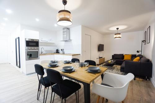 une cuisine et un salon avec une table et des chaises dans l'établissement Spacious Apartment near the Champs de Mars, à Paris