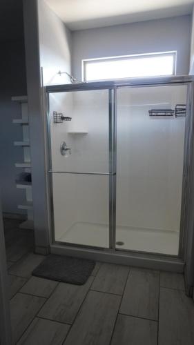 a glass refrigerator with two doors in a room at Lovely white grey home 3 bedrooms in Buckeye
