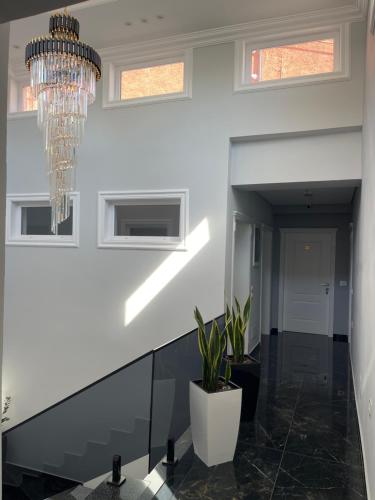 a hallway with a chandelier in a house at Stone Bazaar Villa in Krujë