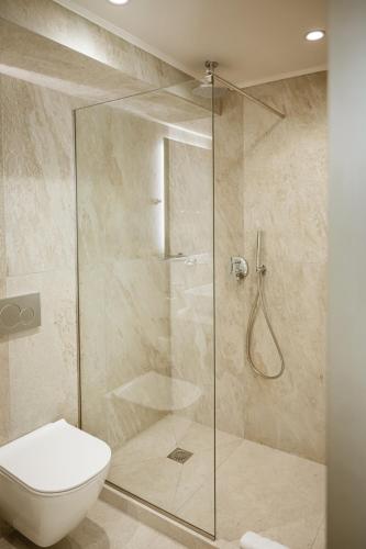 a bathroom with a shower and a toilet at Zante Sun Resort in Lithakia