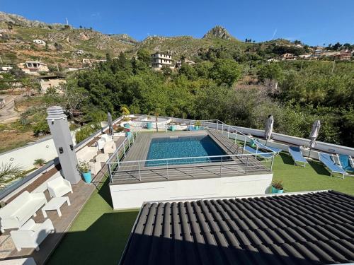 a swimming pool on the roof of a house at New River Hotel in Borgetto