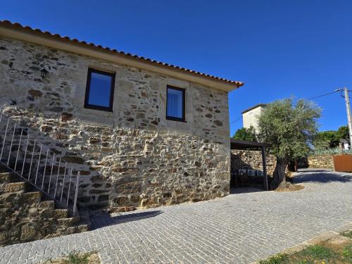 a stone building with a stone staircase next to it at Recanto do Eido in Ponte de Lima