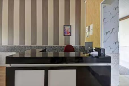 an office with a desk with a chair in it at Hotel O Talegaon MIDC Formerly Goodluck Lodge in Pune