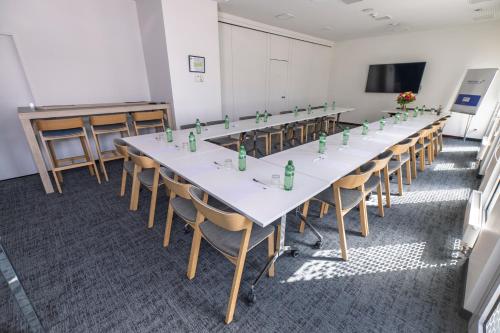 a conference room with a long table and chairs at Holiday Inn Express Geneva Airport by IHG in Geneva
